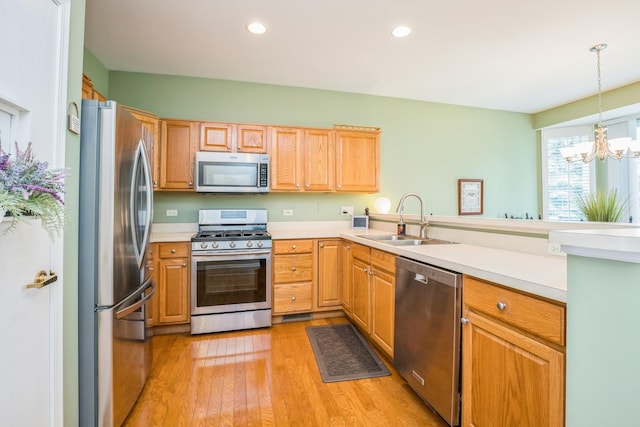 11397 Stonewater Xing, Huntley, IL 60142 - kitchen with stainless steel appliances, a chandelier, light wood-style flooring, light countertops, and recessed lighting