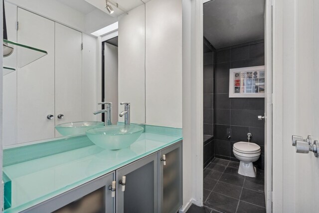 1300 N Astor St Unit 26C, Chicago, IL 60610 - bathroom with tile patterned flooring, vanity, and tile walls