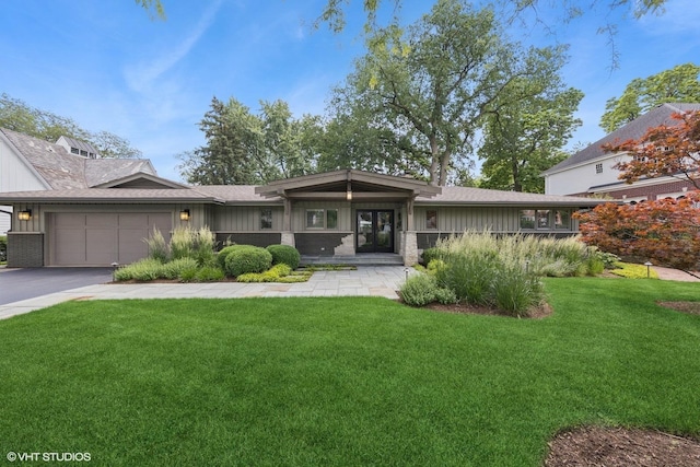 19 N Stough St, Hinsdale, IL 60521 - view of front of house featuring board and batten siding, a garage, a front lawn, driveway, and french doors