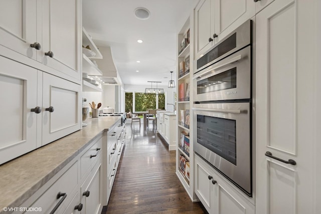 19 N Stough St, Hinsdale, IL 60521 - kitchen with stainless steel double oven, open shelves, dark wood-type flooring, white cabinetry, and recessed lighting