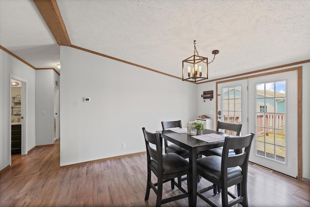 510 W Rhodes St, Thomasboro, IL 61878 - dining space with ornamental molding, wood finished floors, a chandelier, and a textured ceiling