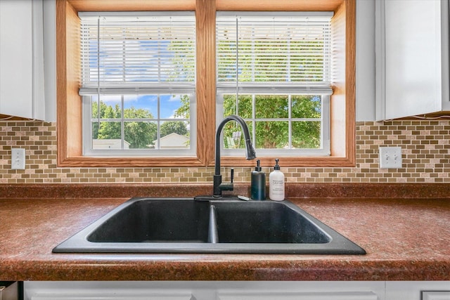 510 W Rhodes St, Thomasboro, IL 61878 - kitchen view of dark countertops, white cabinetry, and backsplash