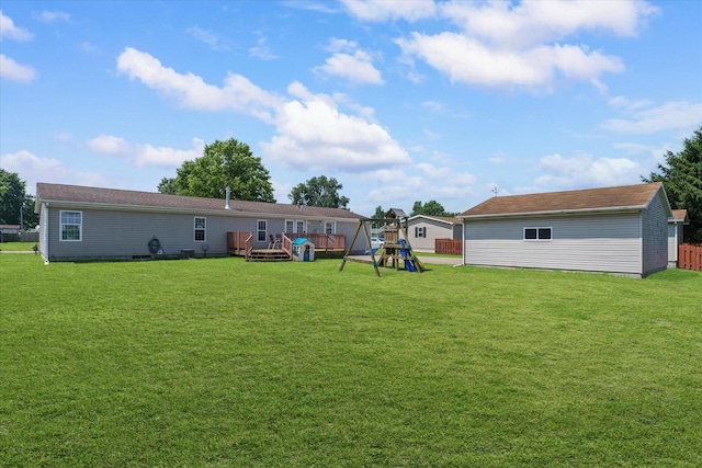 510 W Rhodes St, Thomasboro, IL 61878 - view of yard with a playground, a wooden deck, and an outbuilding