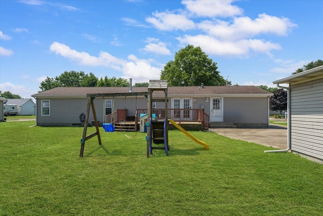 510 W Rhodes St, Thomasboro, IL 61878 - rear view of house featuring a playground and a yard