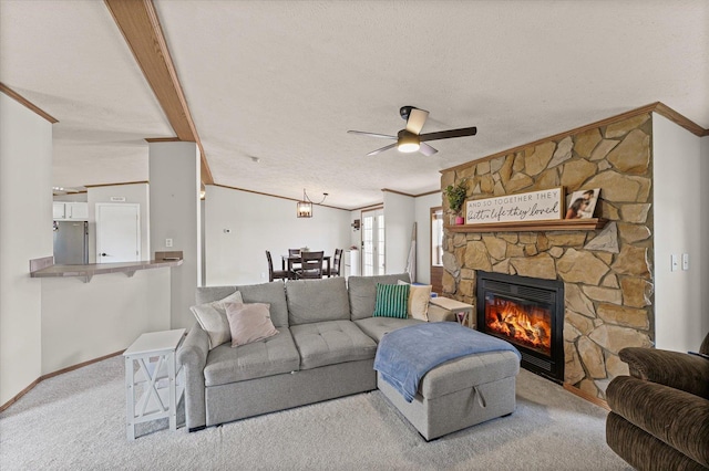 510 W Rhodes St, Thomasboro, IL 61878 - carpeted living area featuring crown molding, ceiling fan, a stone fireplace, and a textured ceiling
