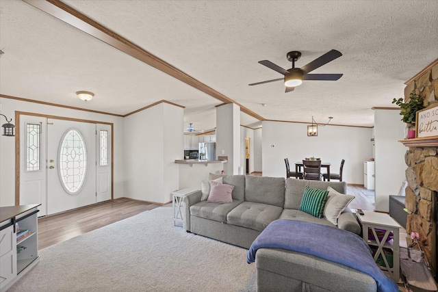 510 W Rhodes St, Thomasboro, IL 61878 - living room with ceiling fan, a textured ceiling, ornamental molding, and wood finished floors