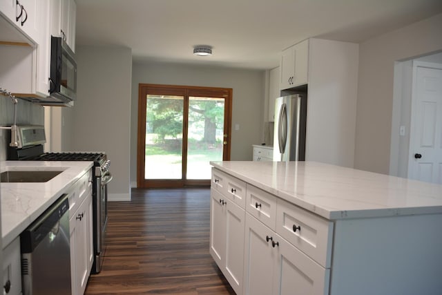 2811 Limerick Dr, Cary, IL 60013 - kitchen featuring stainless steel appliances, dark wood finished floors, white cabinets, light stone countertops, and a center island
