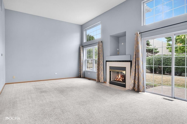1422 Citadel Dr Unit 0, Joliet, IL 60435 - unfurnished living room with carpet flooring, a towering ceiling, and a fireplace with flush hearth