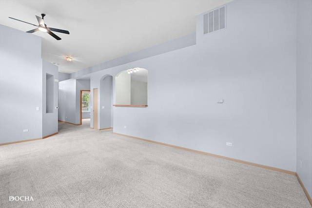 1422 Citadel Dr Unit 0, Joliet, IL 60435 - empty room featuring light colored carpet, ceiling fan, and arched walkways