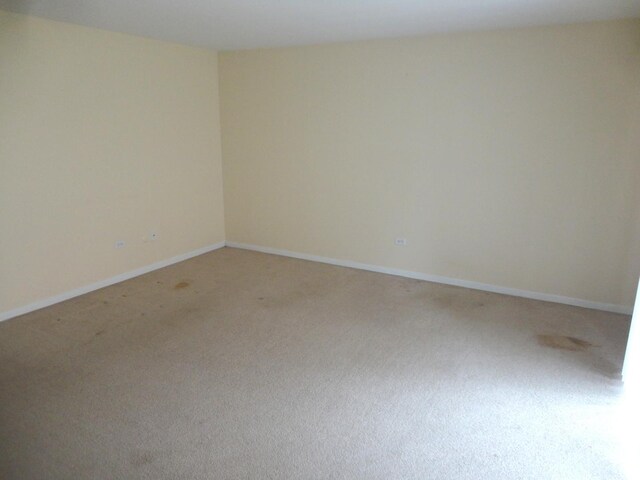 9703 Bianco Ter Unit B, Des Plaines, IL 60016 - unfurnished room with light carpet and baseboards