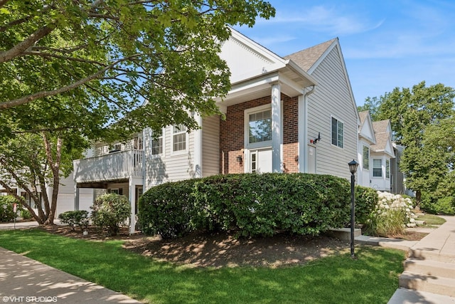 201 Hidden Creek Ln Unit 201, North Aurora, IL 60542 - view of front of property featuring brick siding and a front yard