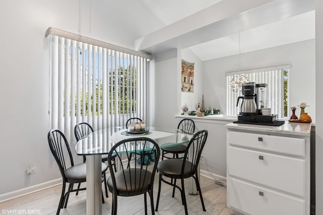 201 Hidden Creek Ln Unit 201, North Aurora, IL 60542 - dining area featuring vaulted ceiling, light wood-type flooring, and a chandelier