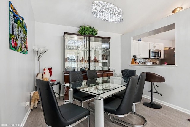 201 Hidden Creek Ln Unit 201, North Aurora, IL 60542 - dining area featuring wood finished floors