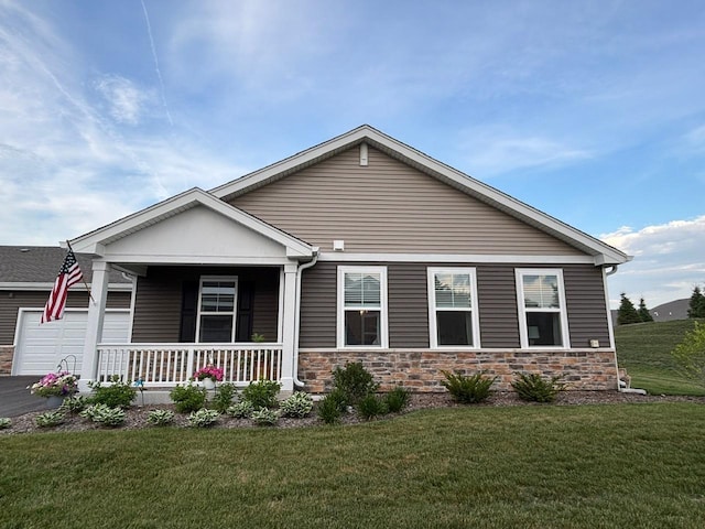 1135 Williamsburg St, Pingree Grove, IL 60140 - view of front of house featuring covered porch, a front yard, a garage, and stone siding