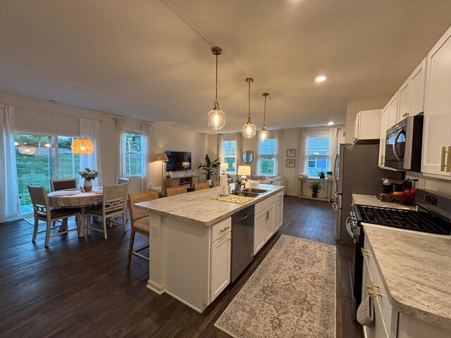 1135 Williamsburg St, Pingree Grove, IL 60140 - kitchen with appliances with stainless steel finishes, a kitchen island with sink, dark wood-style flooring, white cabinets, and recessed lighting
