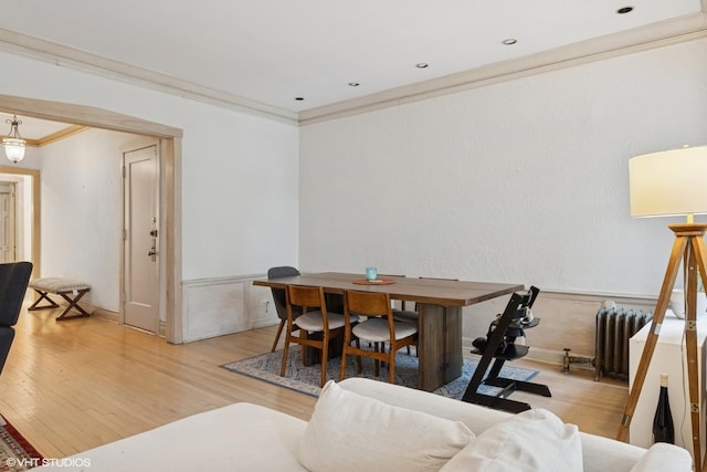 622 W Waveland Ave Unit 2W, Chicago, IL 60613 - dining room with radiator, crown molding, wood finished floors, and wainscoting