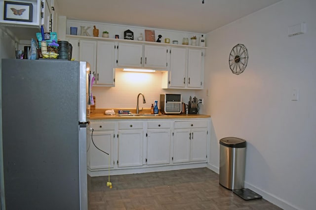 516 Clifton Dr, Round Lake Park, IL 60073 - kitchen featuring freestanding refrigerator, white cabinets, and light countertops