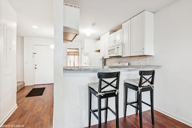 5916 Meadow Dr Unit 149-A, Lisle, IL 60532 - kitchen featuring white appliances, dark wood-style floors, a breakfast bar area, and white cabinets