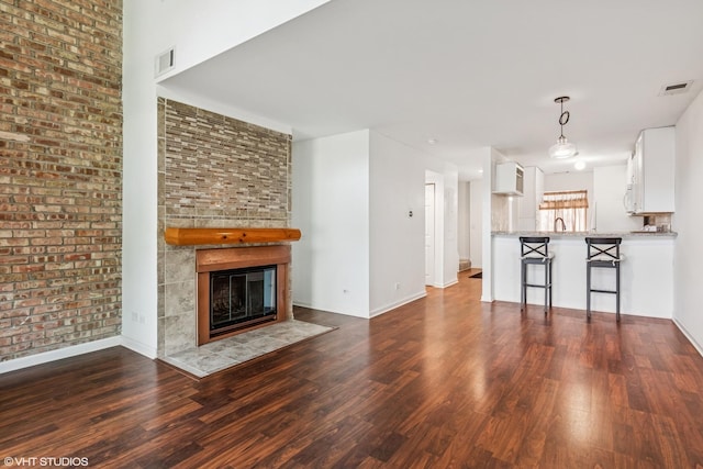 5916 Meadow Dr Unit 149-A, Lisle, IL 60532 - unfurnished living room featuring wood finished floors and a tile fireplace