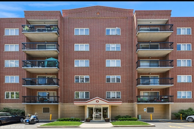 1470 Jefferson St Unit 602, Des Plaines, IL 60016 - view of apartment building / complex featuring uncovered parking