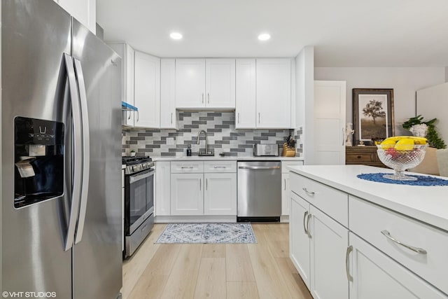 1470 Jefferson St Unit 602, Des Plaines, IL 60016 - kitchen featuring appliances with stainless steel finishes, light countertops, light wood-style floors, white cabinetry, and recessed lighting