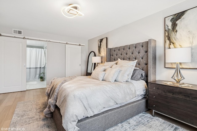 1470 Jefferson St Unit 602, Des Plaines, IL 60016 - bedroom with wood finished floors and a barn door