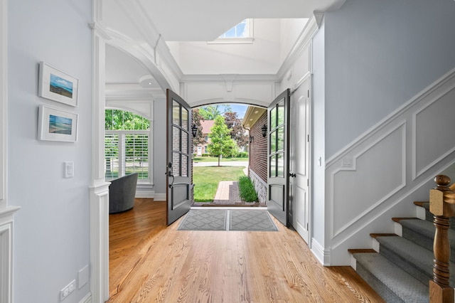 2115 Washington Ave, Wilmette, IL 60091 - foyer entrance featuring light wood finished floors, a decorative wall, stairway, and crown molding