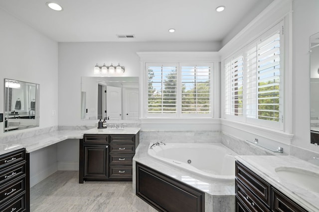 2115 Washington Ave, Wilmette, IL 60091 - bathroom with healthy amount of natural light, two vanities, a whirlpool tub, and recessed lighting