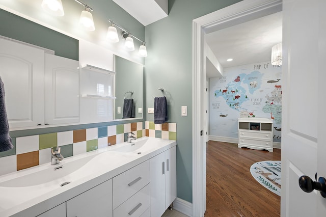 2115 Washington Ave, Wilmette, IL 60091 - full bathroom featuring double vanity, wood finished floors, and tasteful backsplash