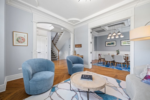 2115 Washington Ave, Wilmette, IL 60091 - living area featuring stairs, arched walkways, ornate columns, and ornamental molding