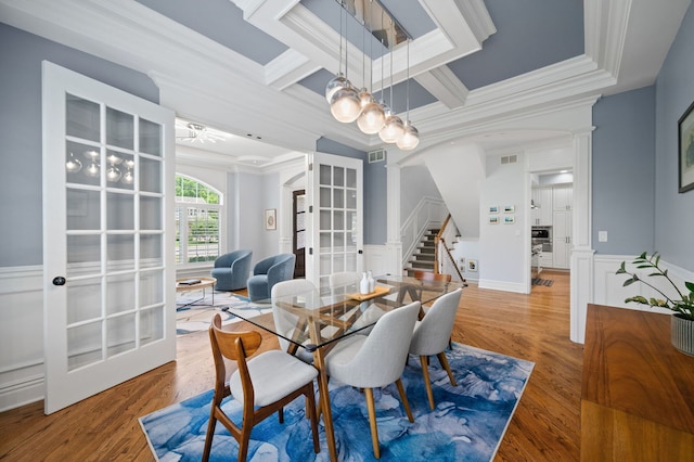 2115 Washington Ave, Wilmette, IL 60091 - dining area featuring crown molding, decorative columns, stairs, arched walkways, and a wainscoted wall