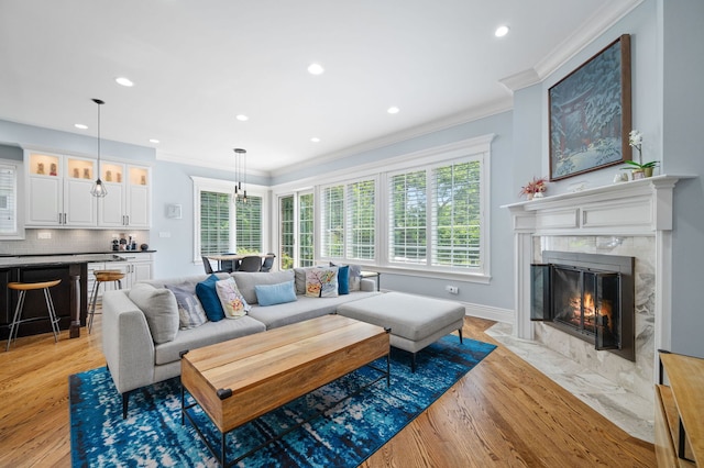 2115 Washington Ave, Wilmette, IL 60091 - living area featuring light wood finished floors, ornamental molding, a premium fireplace, and recessed lighting