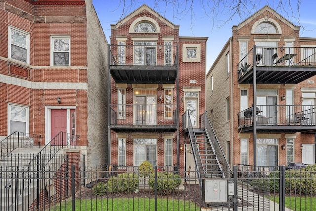 4809 S Wabash Ave Unit 3, Chicago, IL 60615 - view of front of property with a balcony, brick siding, a fenced front yard, and a gate