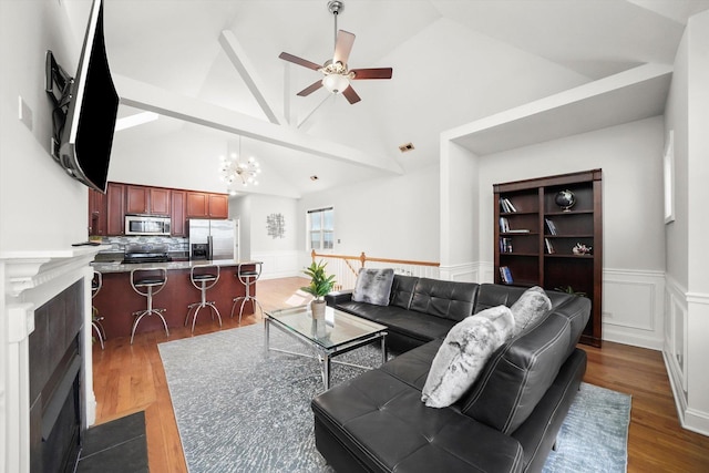 4809 S Wabash Ave Unit 3, Chicago, IL 60615 - living room with a chandelier, a ceiling fan, a fireplace with flush hearth, wood finished floors, and a wainscoted wall