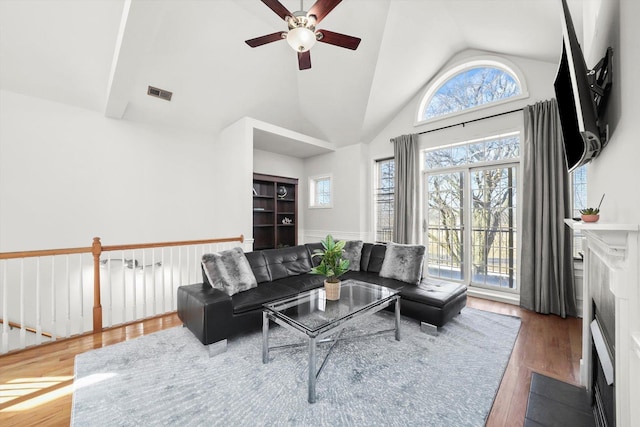 4809 S Wabash Ave Unit 3, Chicago, IL 60615 - living area with wood finished floors, a ceiling fan, healthy amount of natural light, high vaulted ceiling, and a fireplace with flush hearth