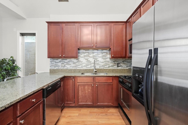 4809 S Wabash Ave Unit 3, Chicago, IL 60615 - kitchen featuring appliances with stainless steel finishes, light wood-style floors, light stone countertops, and decorative backsplash
