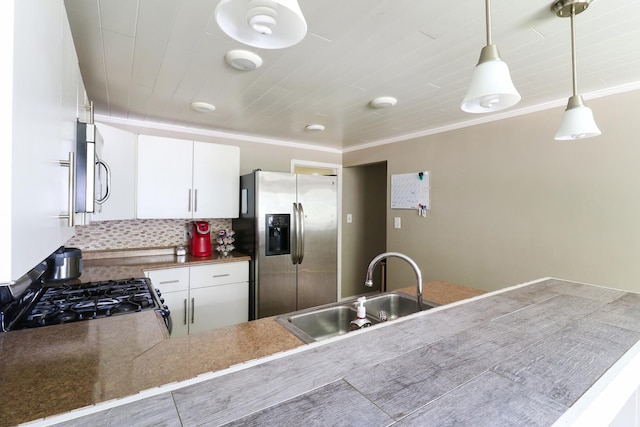 325 W Poplar St S, Heyworth, IL 61745 - kitchen featuring appliances with stainless steel finishes, tasteful backsplash, hanging light fixtures, ornamental molding, and white cabinetry