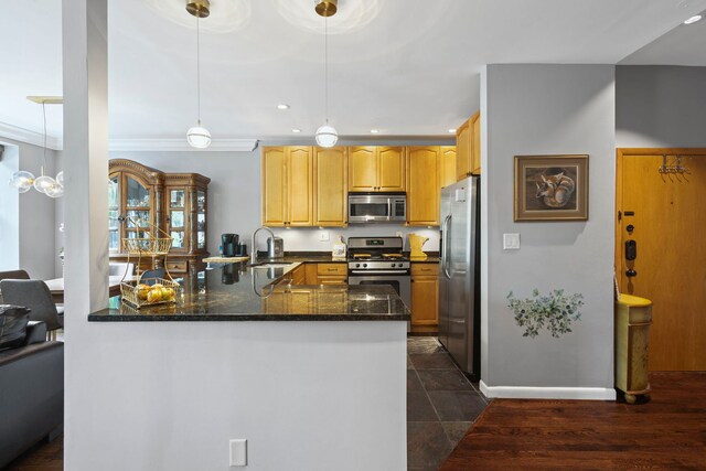 4026 N Clarendon Ave Unit 2N, Chicago, IL 60613 - kitchen with stainless steel appliances, a peninsula, dark stone counters, decorative light fixtures, and recessed lighting