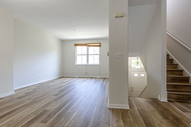 6163 Mayfair St, Morton Grove, IL 60053 - unfurnished living room with wood finished floors and stairway