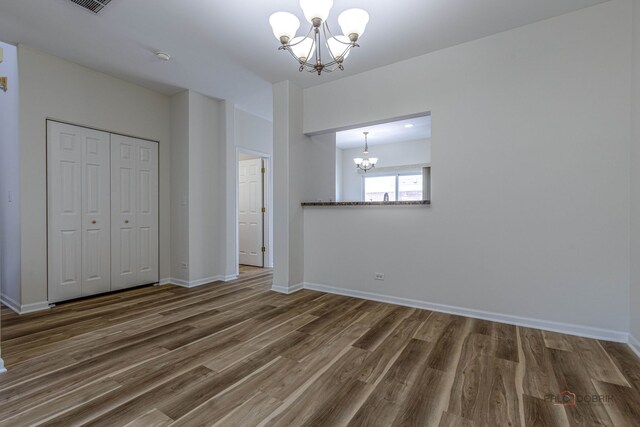 6163 Mayfair St, Morton Grove, IL 60053 - unfurnished bedroom with a chandelier, wood finished floors, and a closet