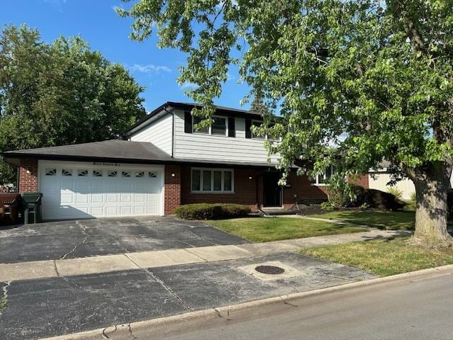 726 E 193rd St, Glenwood, IL 60425 - traditional-style home with a garage, a front lawn, brick siding, and driveway