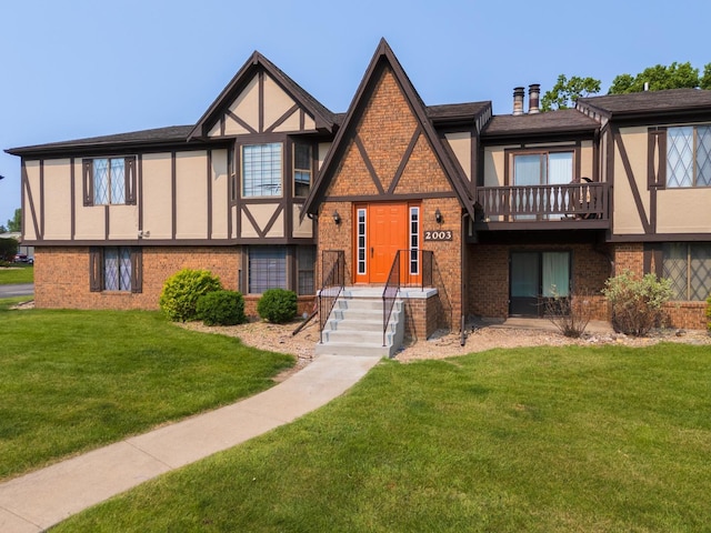 2003 Tracy Dr Unit 1, Bloomington, IL 61704 - tudor house with stucco siding, brick siding, and a front lawn
