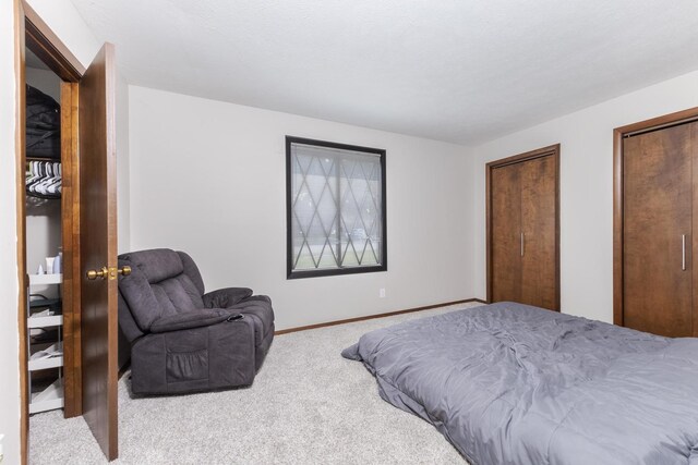 2003 Tracy Dr Unit 1, Bloomington, IL 61704 - carpeted bedroom with multiple closets and baseboards