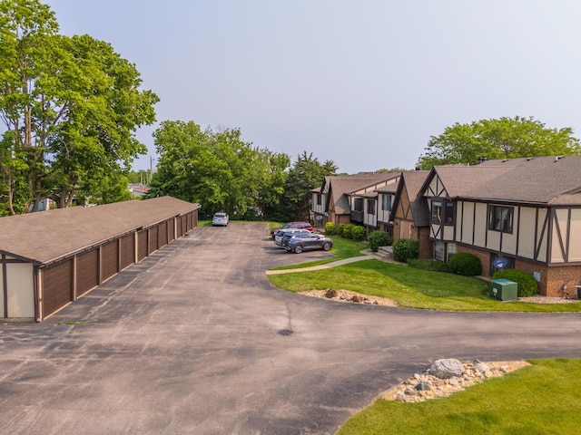 2003 Tracy Dr Unit 1, Bloomington, IL 61704 - view of front of home featuring community garages, a front yard, a residential view, and brick siding