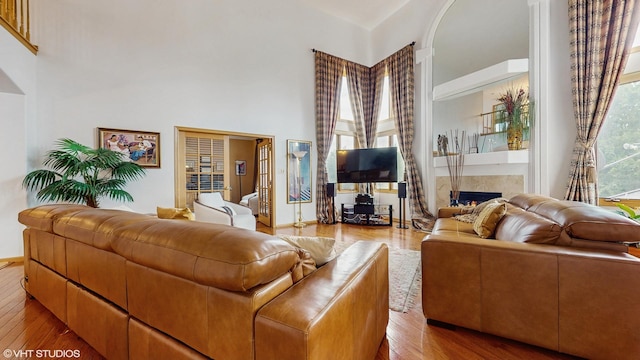 11 Carrington Ct, Hazel Crest, IL 60429 - living room featuring a towering ceiling, a high end fireplace, and wood finished floors