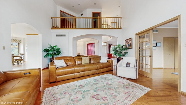 11 Carrington Ct, Hazel Crest, IL 60429 - living room featuring arched walkways, wood finished floors, and a high ceiling