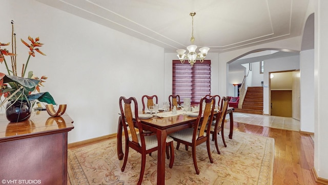 11 Carrington Ct, Hazel Crest, IL 60429 - dining room with arched walkways, wood finished floors, stairway, and a chandelier