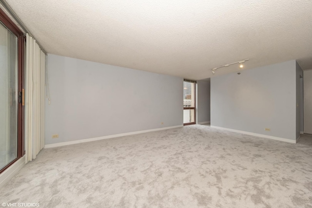 200 N Dearborn St Unit 1803, Chicago, IL 60601 - spare room featuring rail lighting, carpet flooring, and a textured ceiling