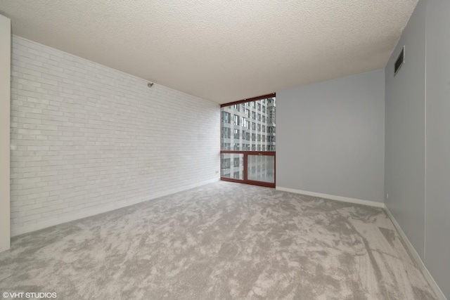 200 N Dearborn St Unit 1803, Chicago, IL 60601 - unfurnished room featuring brick wall, carpet flooring, and a textured ceiling
