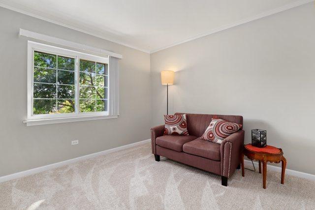 3256 Sanders Rd Unit 4E, Northbrook, IL 60062 - living area featuring crown molding and carpet floors